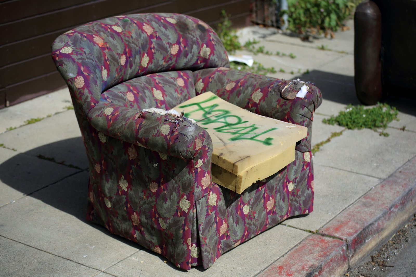 A chair sitting on the side of a street